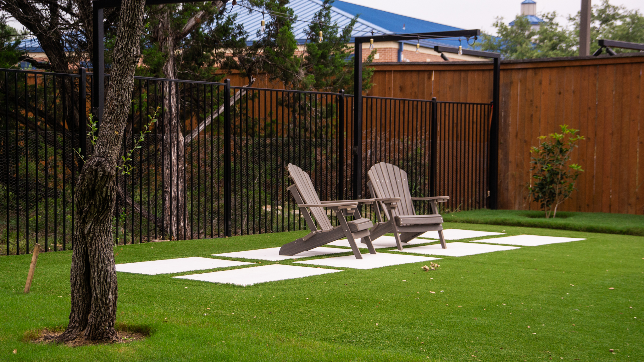 Back fence seating area under light poles